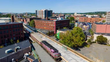 Aerial view of purple MBTA commuter train at station in Lynn, Massachusetts.